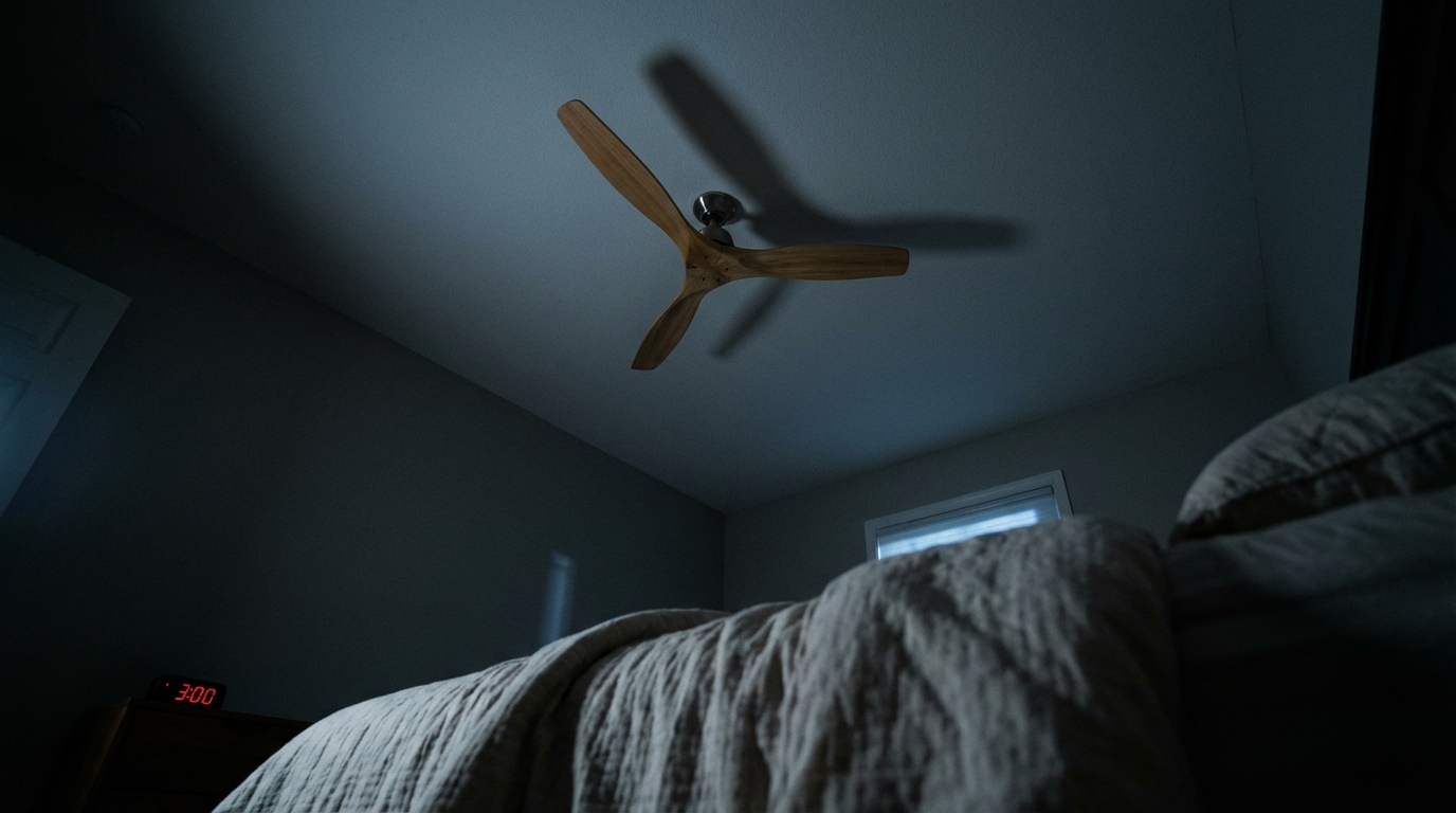 Ceiling fan and faint clock glow during a sleepless night
