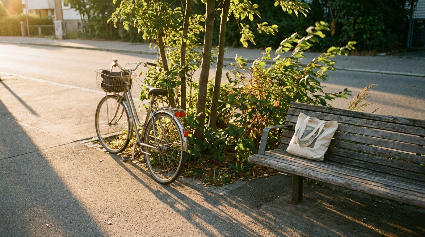 Quiet sidewalk scene with a bicycle and warm evening light