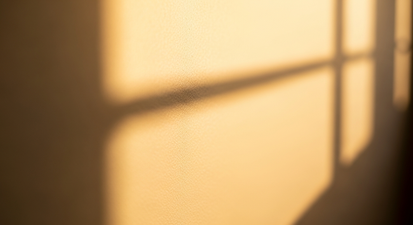 Morning light and a soft shadow line on a hallway wall